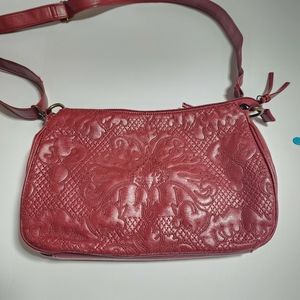 Red leather crossbody bag with embroidery detail on the front